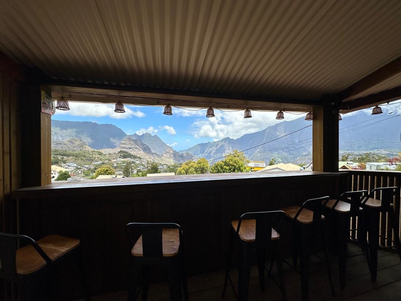 Bar couvert du Chalet Des Sens à Cilaos avec vue panoramique sur les montagnes du cirque de Cilaos, La Réunion